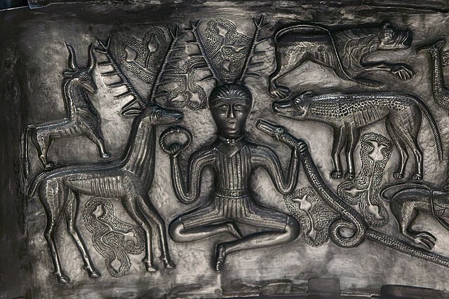 A photo of the Gundestrup Cauldron's famous interior Panel A, featuring Cernunnos with the animals.