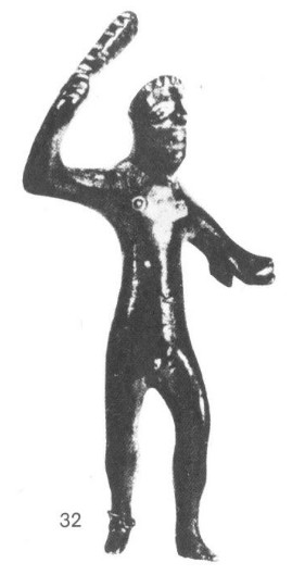 A black-and-white photocopied image of a shiny bronze statuette of a man wielding a club over His head. His proportions are unnatural and His physique looks rounded and rubbery, almost like a Stretch Armstrong action figure. His nipples are shaped like bullseyes and His eyes look like sloping globules. His hair is a neat row of incisions that sits on top of His head kind of like a crown.