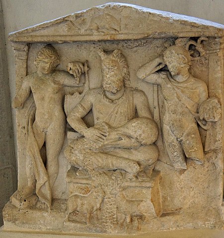 Photo of the Reims Stela, a limestone relief showing Cernunnos, Apollo, and Mercury, as described above.