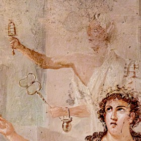 Closeup of a faded Roman fresco showing a priest of Isis holding out a sistrum in one hand and gleaming gold caduceus in the other. He wears a toga and laurel wreath, with a small metal pot hanging from his wrist.