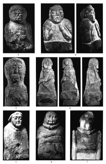 A collage of seven different bustes in black-and-white photographs. They have simple and even comical designs, with charming and unique faces. Some look startled or afraid while others are more calm and content. Most are crudely sculpted, although a couple approach naturalism. Some wear torcs and some have arms while others are just a plain base with a head on it. One is a woman Who has long hair, the others are men with slicked back hair. The woman is the only one Who holds some sort of long object in each hand.