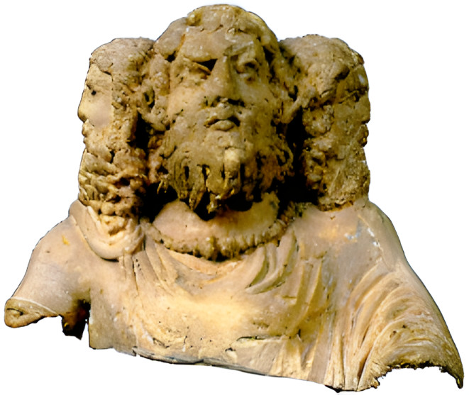 A beige stone bust of a three-headed God in Roman style. He is a middle-aged looking man with a long beard. An eyebrow is arched in a quizzical or unamused expression. The other two heads face opposite right and left. He has a wide torc whose and is wears a toga.